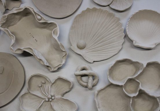 Diverse ongeglazuurde keramische schalen en vormen in natuurlijke ontwerpen.
